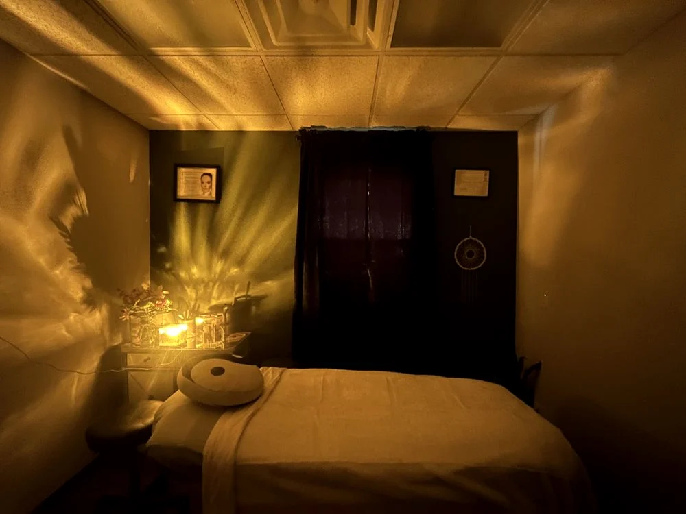A candlelit treatment room, warm and low-lit