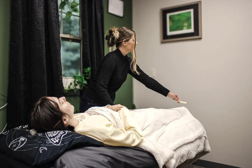 Hannah working with a client during a Reiki session in her Portland studio